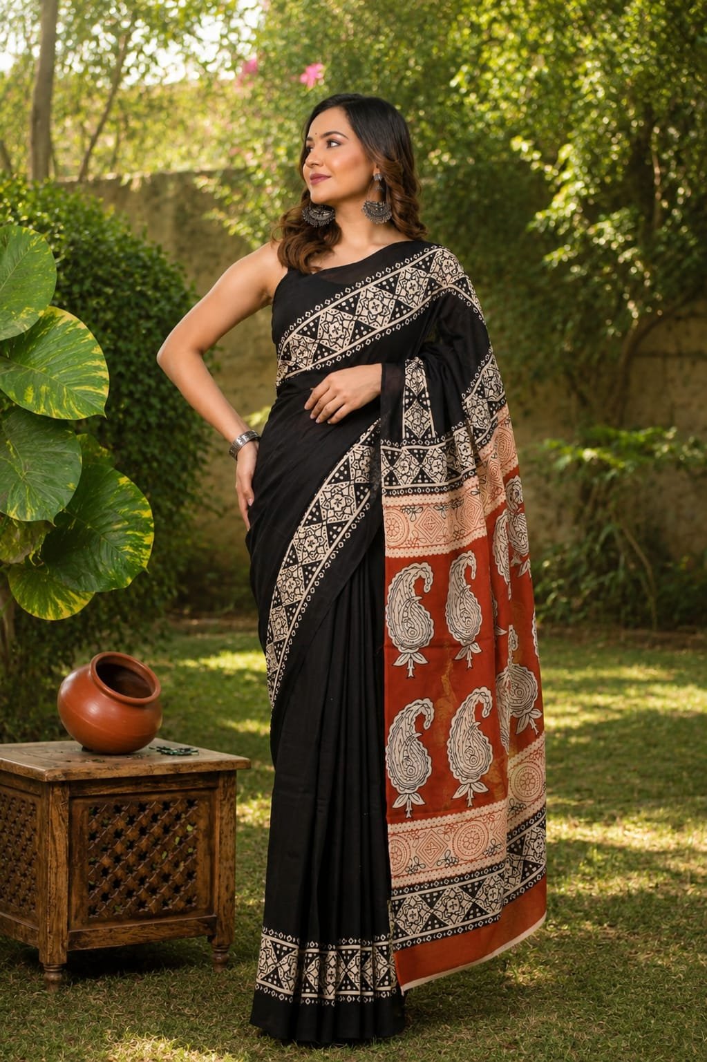 Black and rust saree with paisley and geometric patterns in traditional Bagru print
