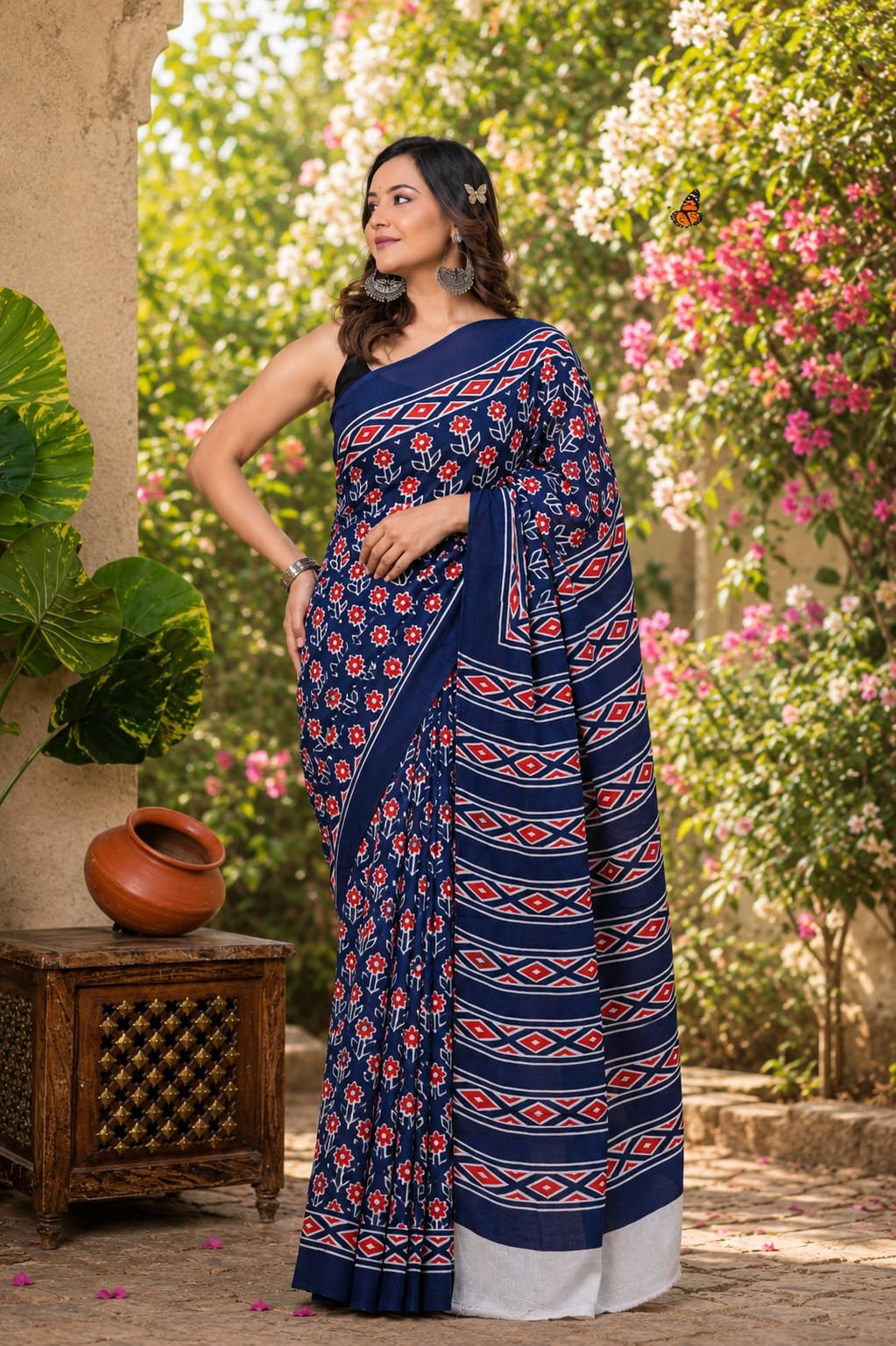 Navy blue saree with red and white floral and geometric motifs