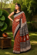 Rust Mul Cotton saree with floral motifs and black borders in Bagru print