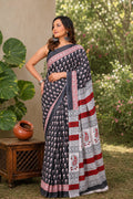 Black and red saree with floral motifs and geometric border in Bagru style