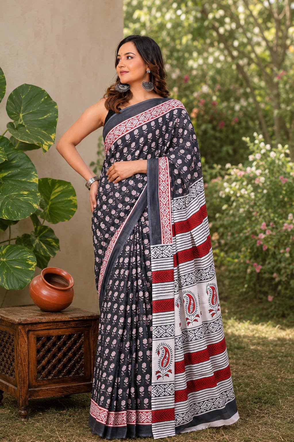 Black and red saree with floral motifs and geometric border in Bagru style