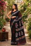 Black saree with floral motifs in red and white Bagru hand block print