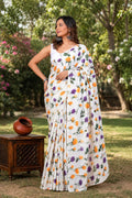 White saree with orange and purple floral motifs in Bagru hand block print