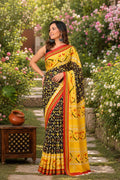 Yellow and black saree with floral motifs and red striped border