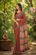 Rust and black saree with geometric and floral motifs, traditional Bagru print