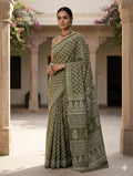 Olive green saree with geometric and floral motifs in Bagru print