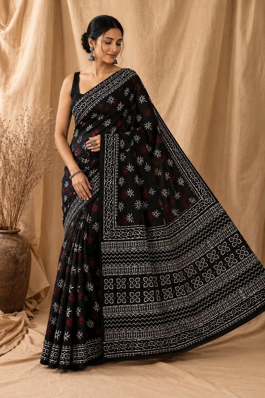 Black saree with white and red floral motifs, intricate border design