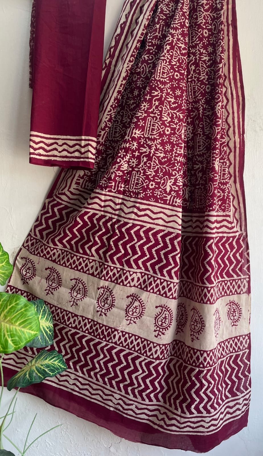 Maroon saree with paisley motifs and chevron border design