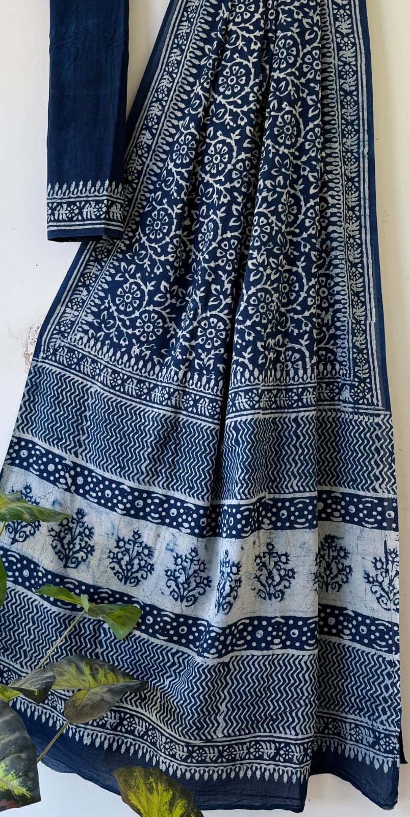 Blue and white saree with floral motifs and intricate border design