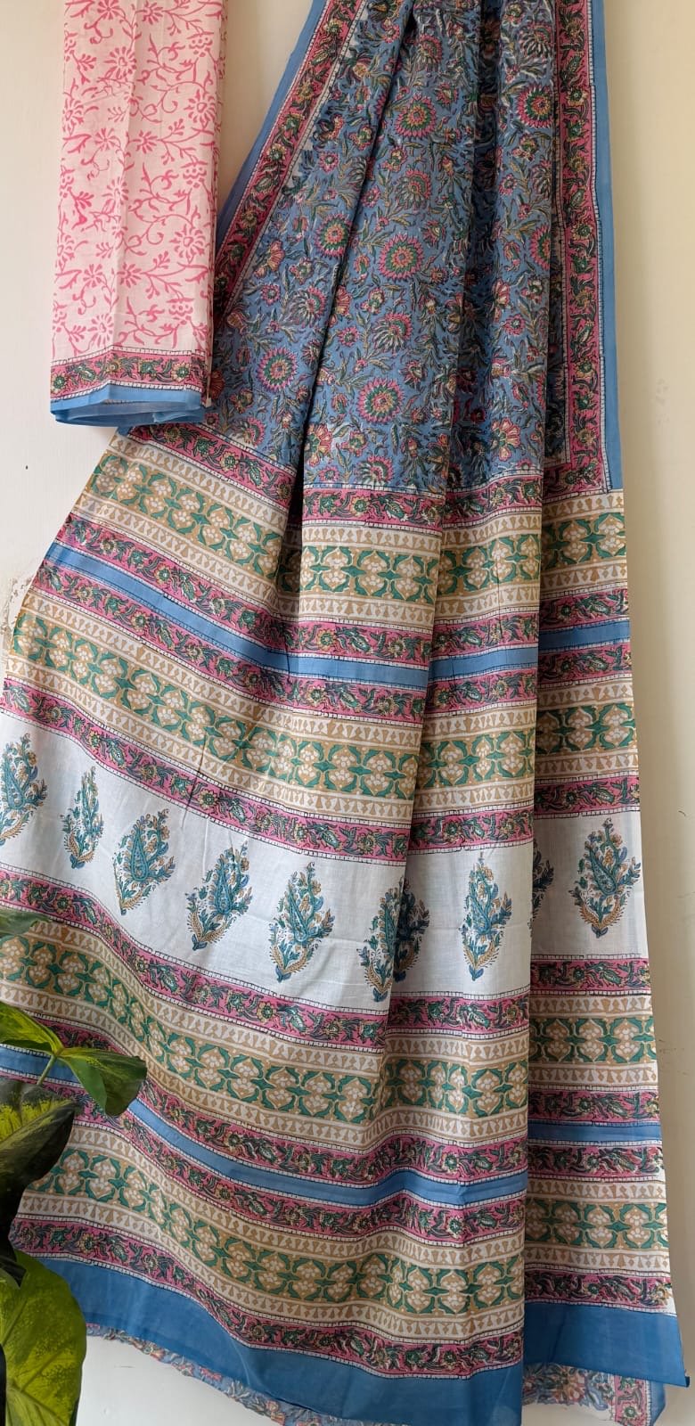 Blue saree with floral motifs, pink and teal border in traditional Bagru print