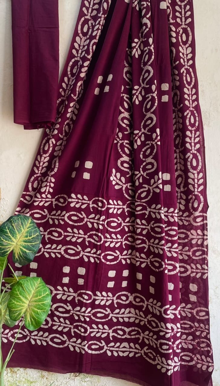 Maroon saree with white floral motifs and border in traditional Bagru style