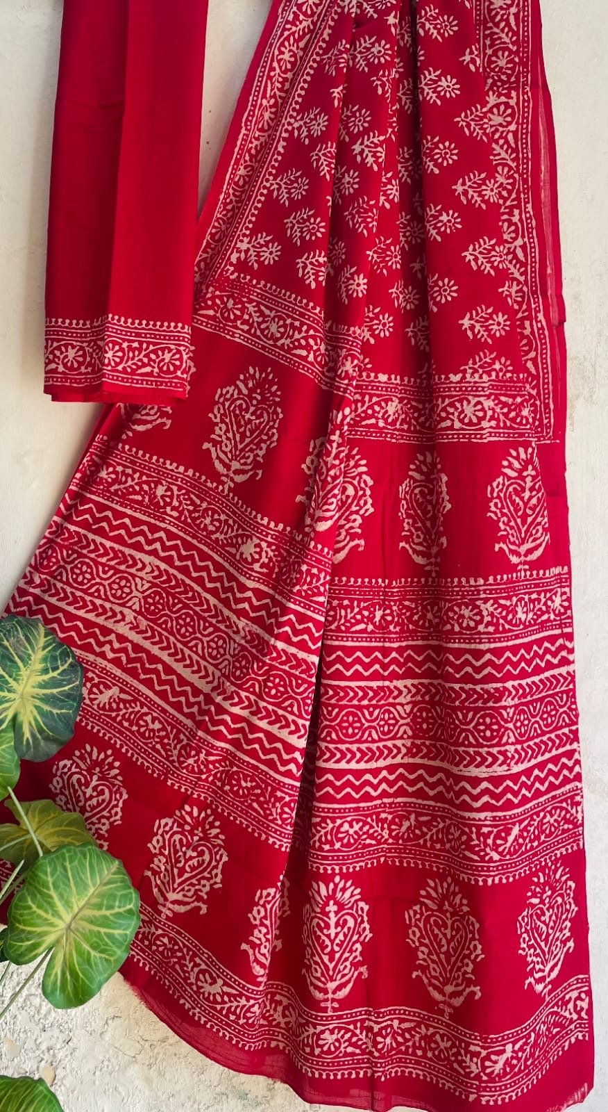 Red saree with floral motifs and intricate border hand block print