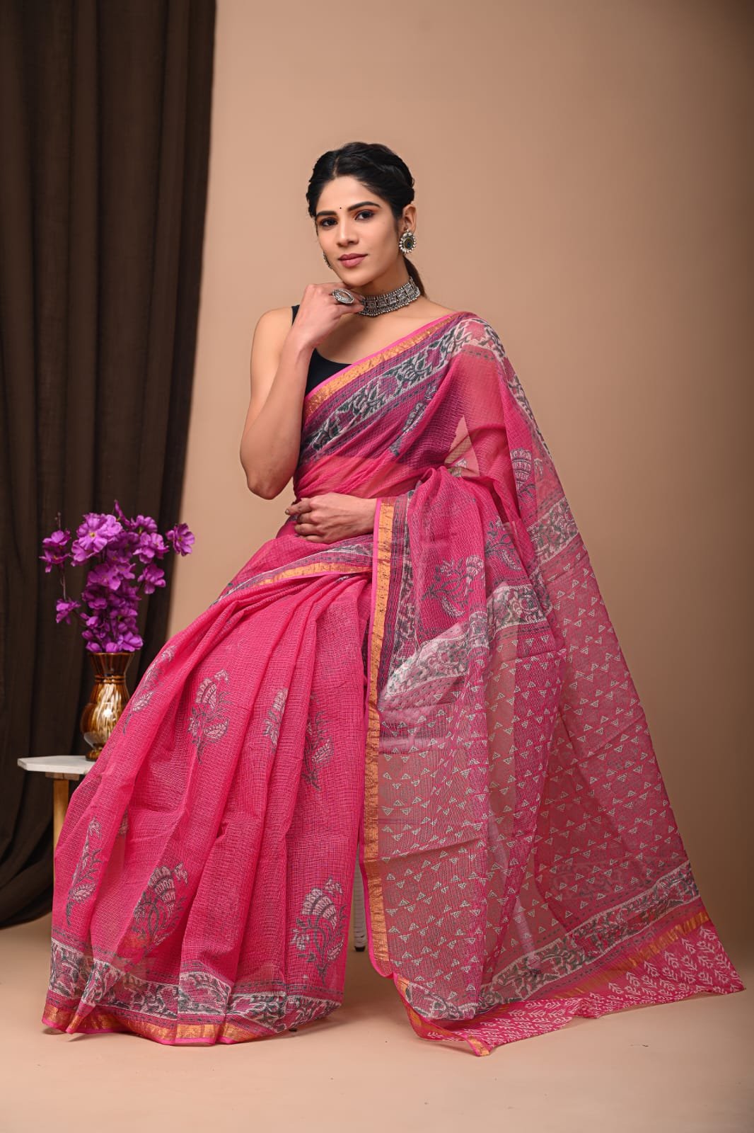 Pink saree with floral motifs and geometric patterns in Kota Doriya fabric