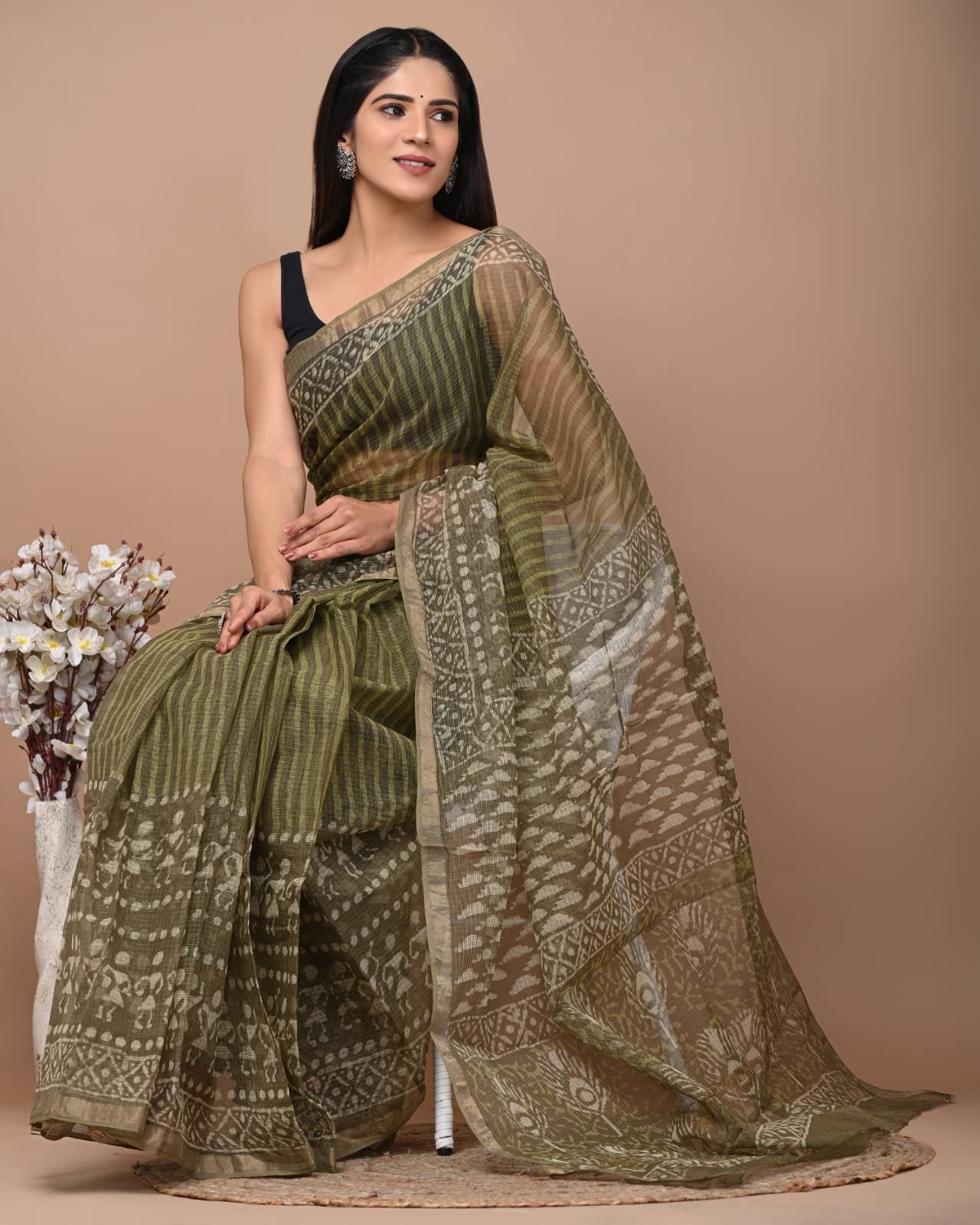 Olive saree with floral and geometric block print motifs and a distinctive border