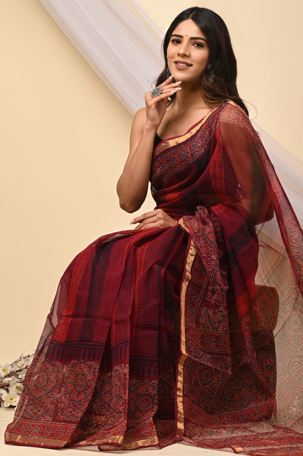 Rich maroon saree featuring floral motifs with Bagru hand block print design.