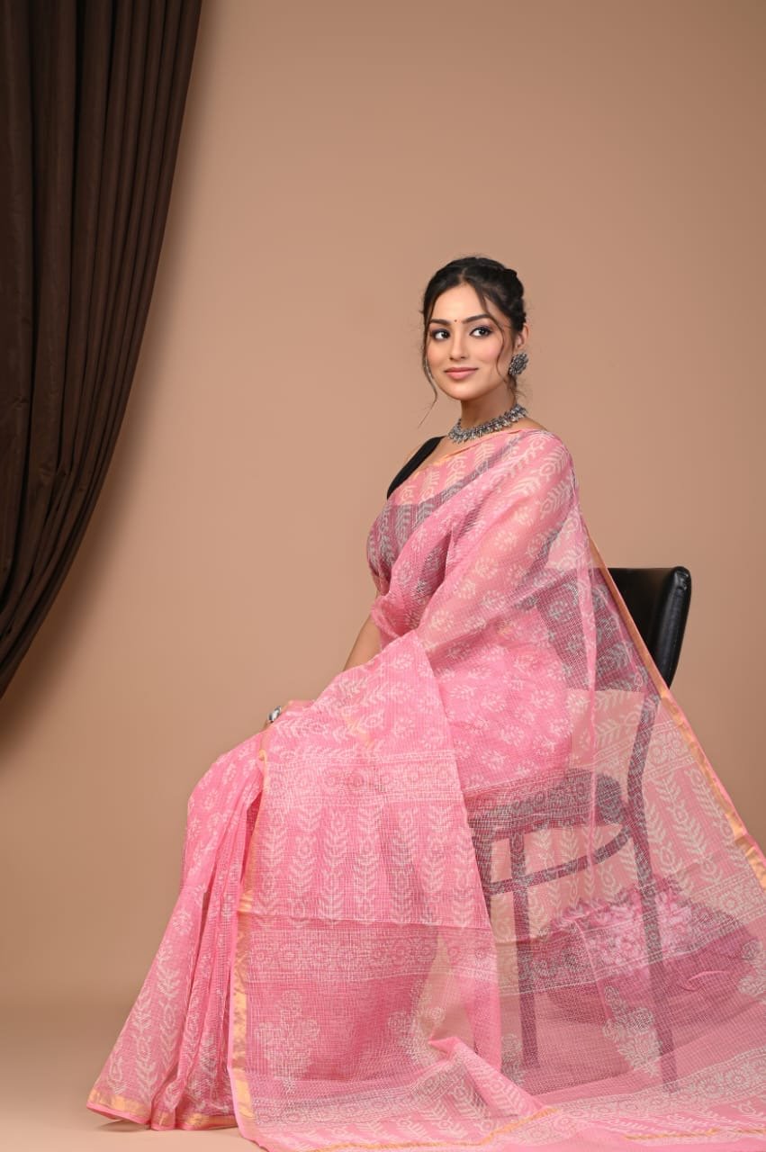 Pink saree with white floral motifs and subtle border design