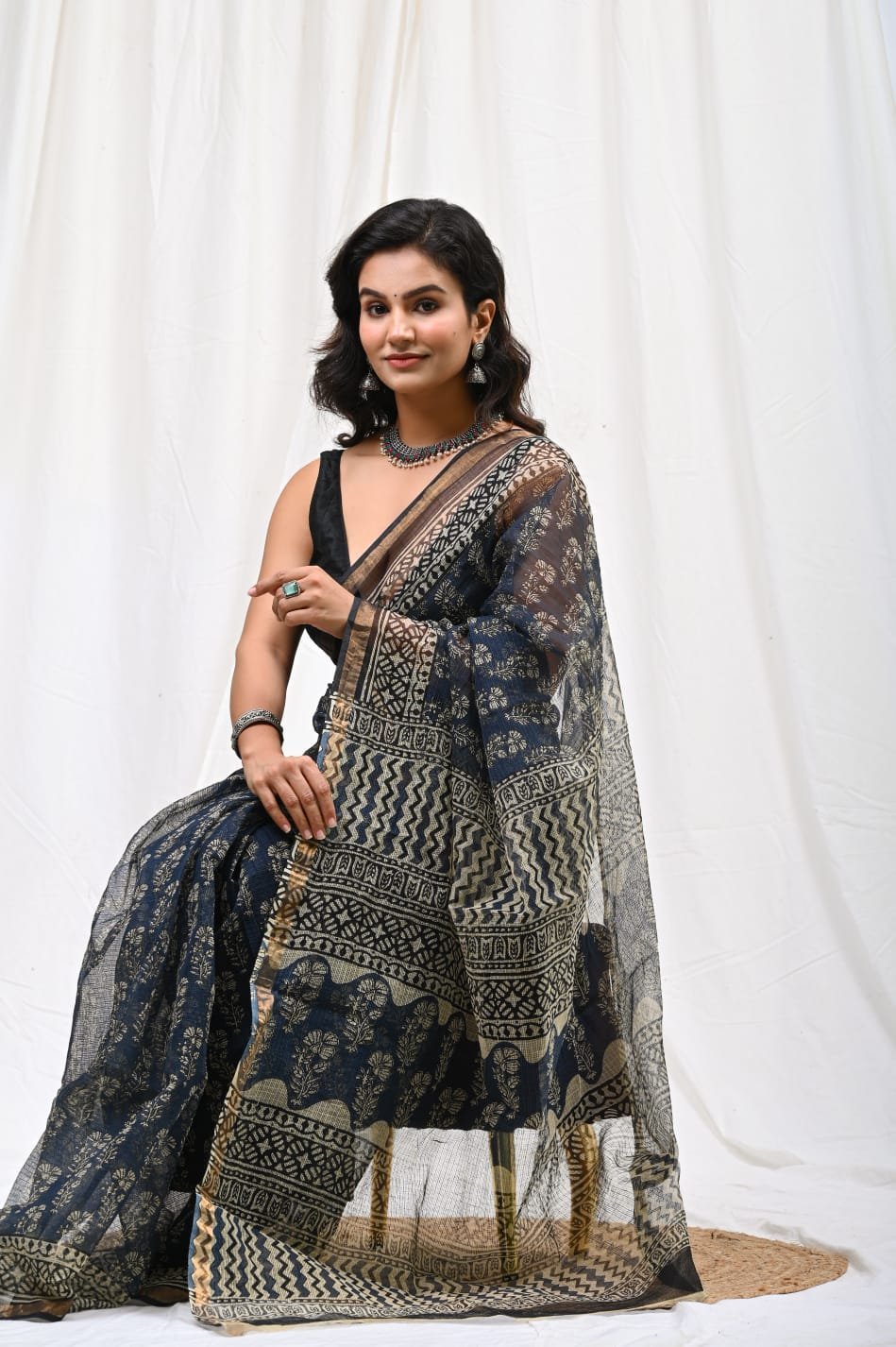 Navy blue Kota Doriya saree with floral Bagru block print and intricate border design