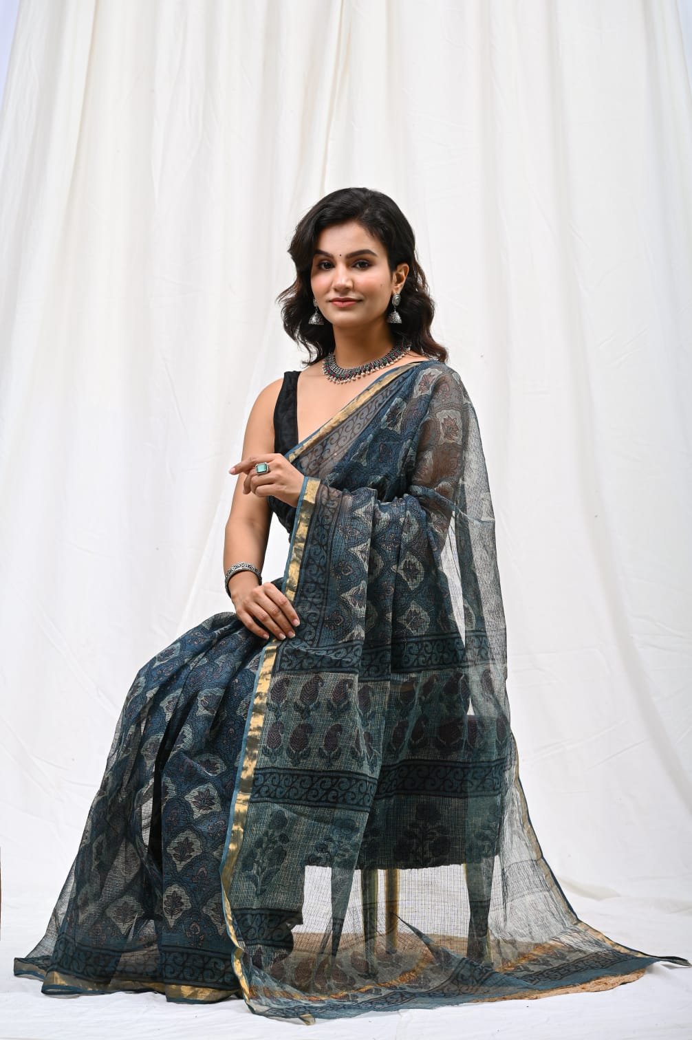 Navy blue saree with floral print and gold border on lightweight Kota Doriya fabric
