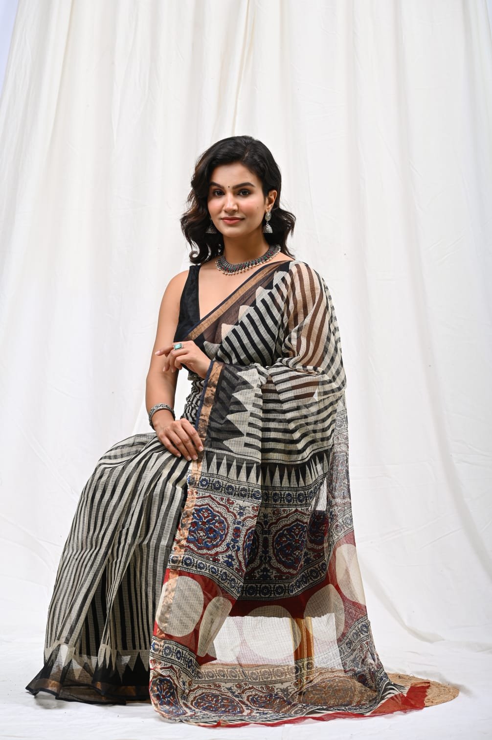 Black and white geometric patterns on Kota Doriya saree with colorful border.