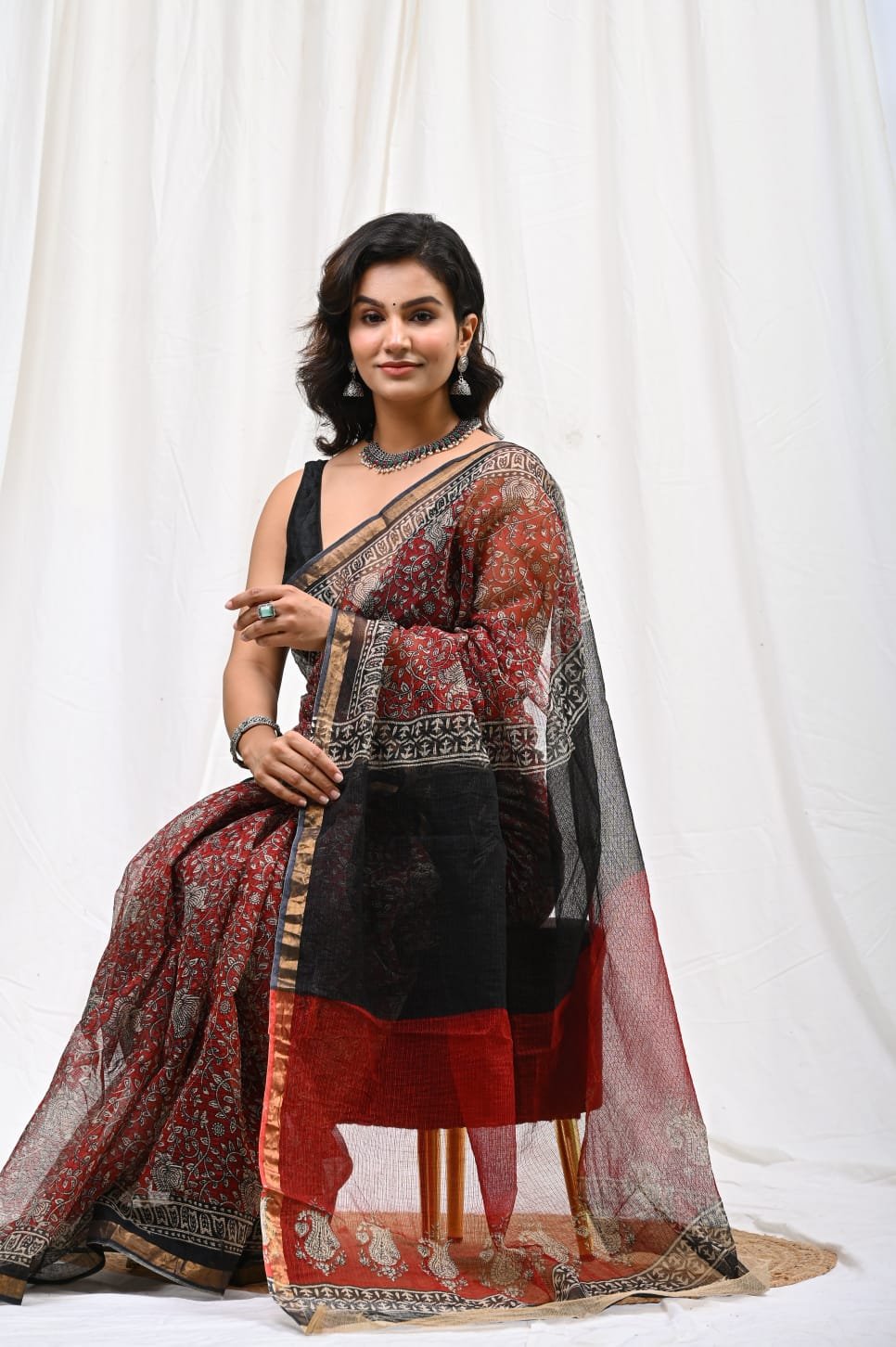 Black and red saree with floral motifs and intricate Bagru hand block print