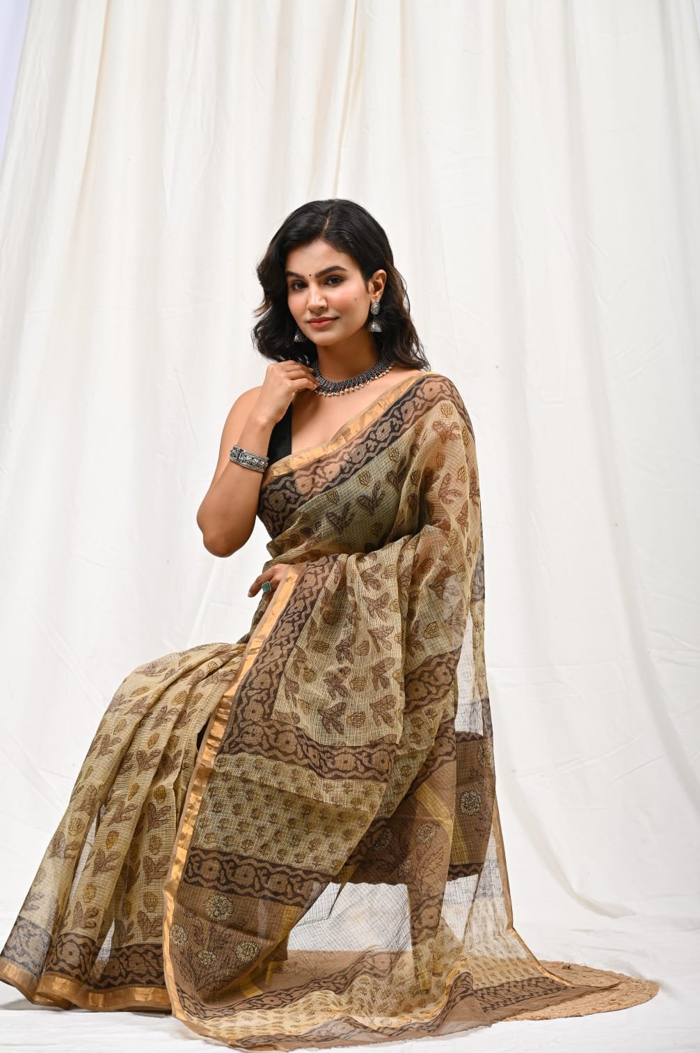Earthy brown saree with floral Bagru print and delicate borders