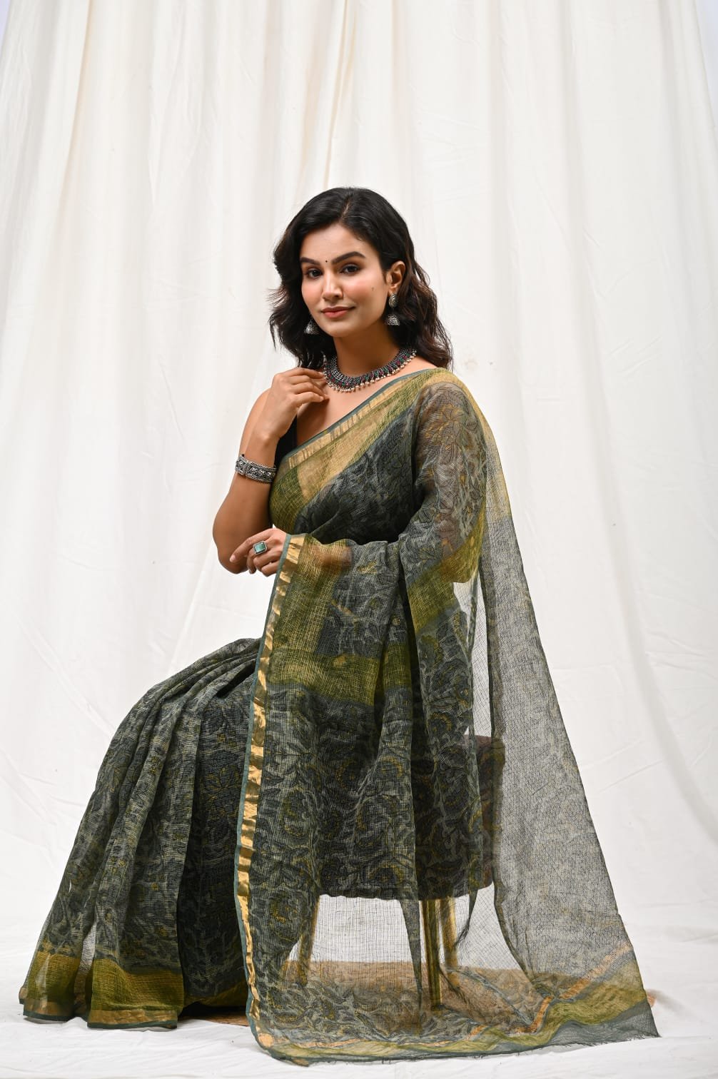 Olive green saree featuring floral motifs with Bagru hand block print pattern