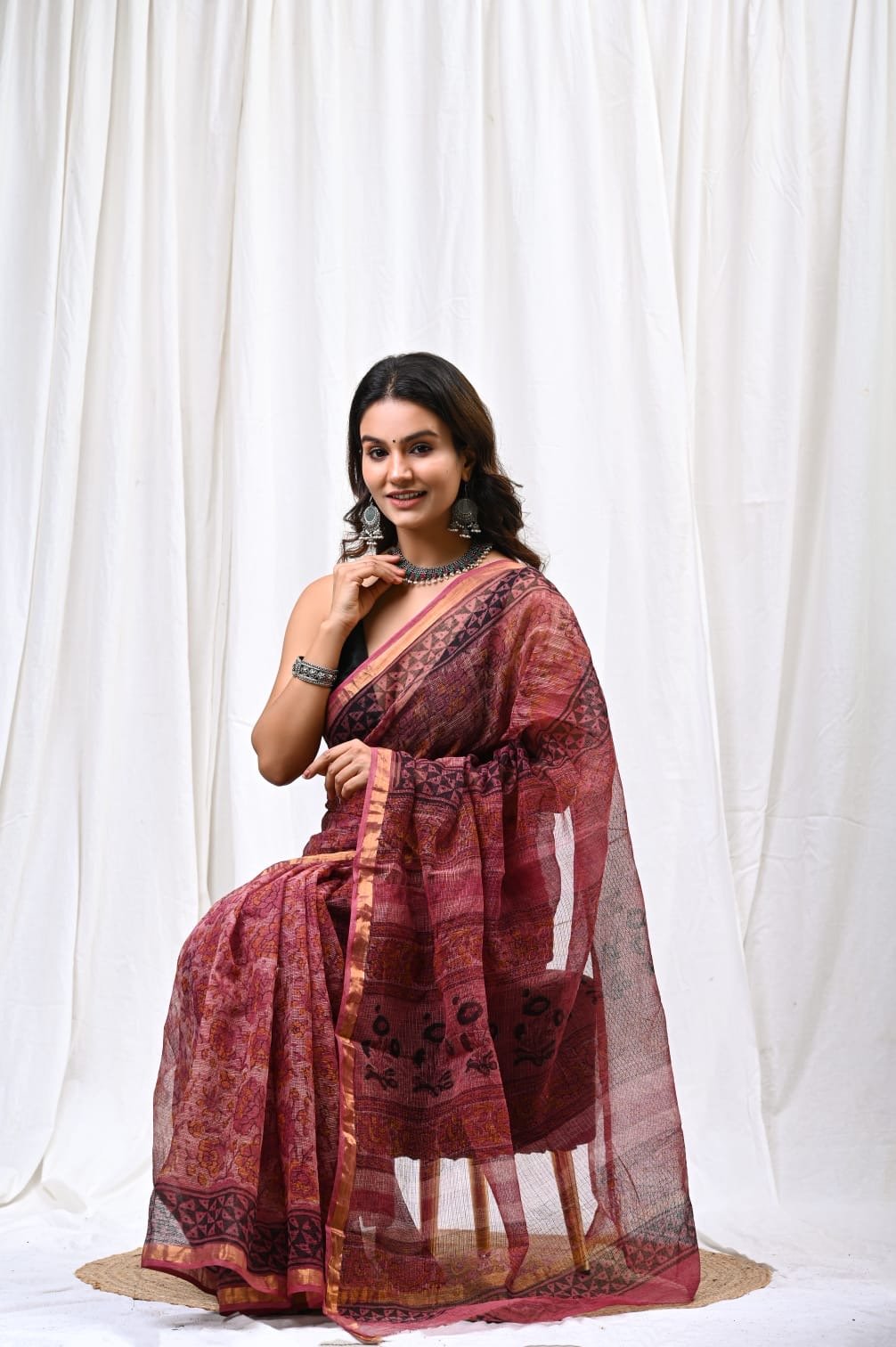 Maroon saree with floral and geometric motifs in Bagru hand block print