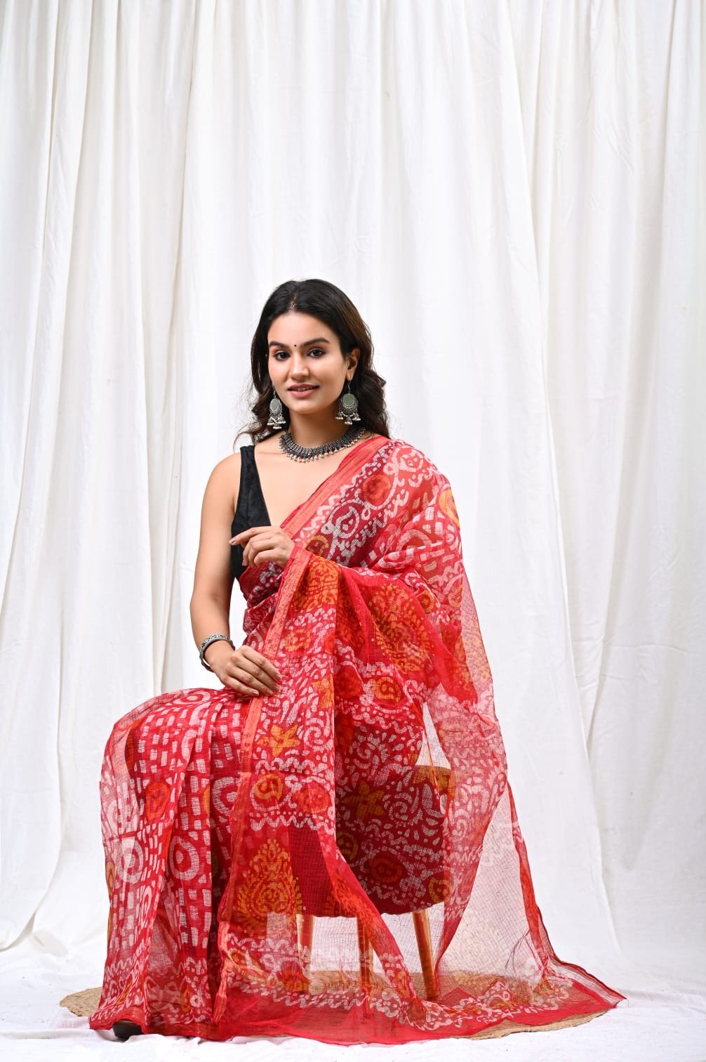 Red saree with floral motifs and geometric patterns in Bagru hand block print