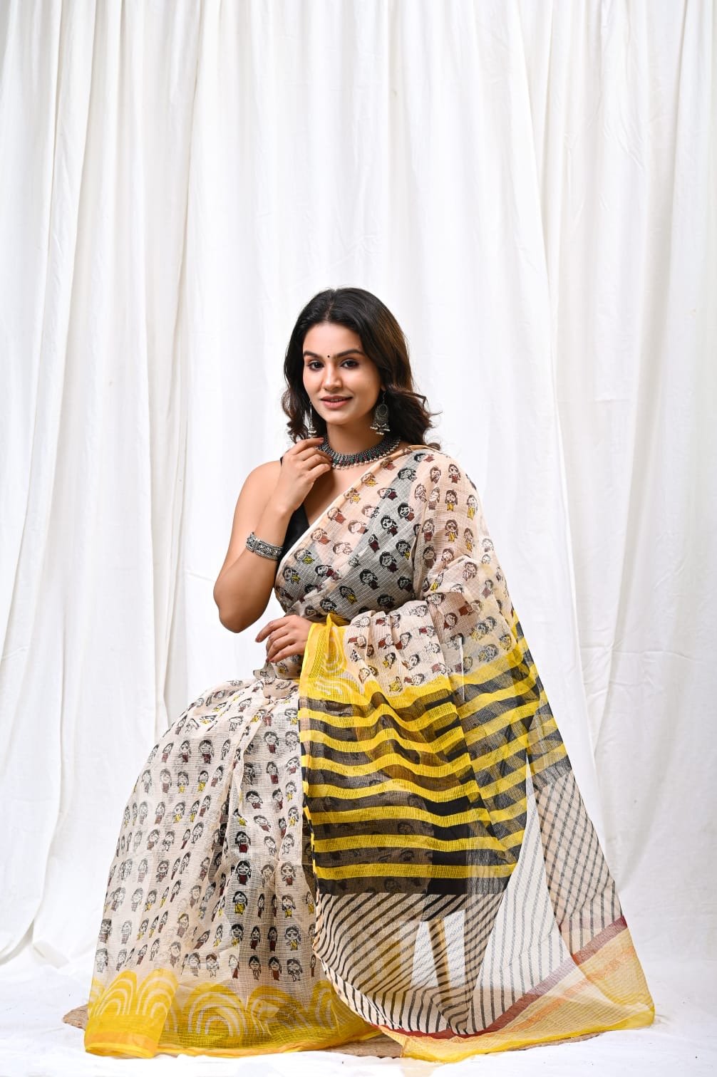 Yellow and black-striped Kota Doriya saree with Bagru hand block print design