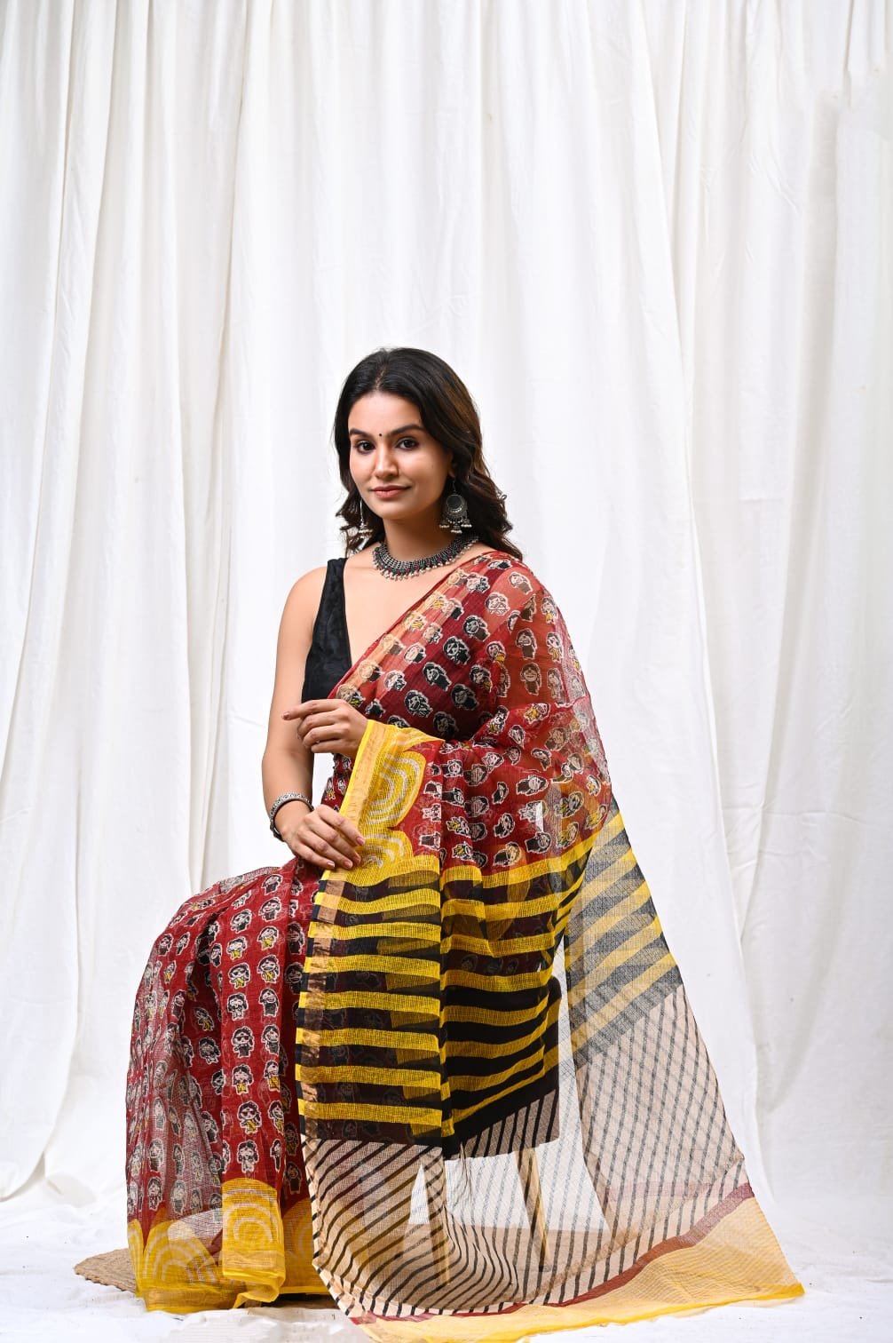Red and yellow saree with floral motifs and striped border in Kota Doriya fabric
