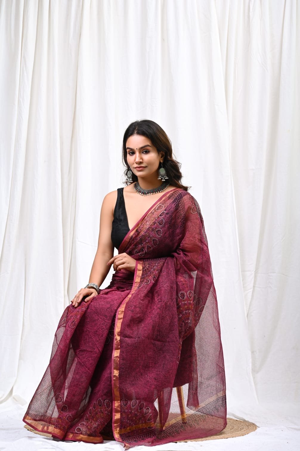 Maroon Kota Doriya saree with floral Bagru hand block print and border design