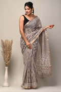 Grey Kota Doriya saree with floral Bagru hand block prints and intricate border patterns.