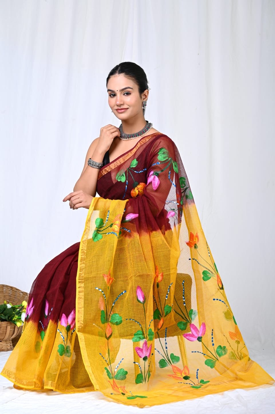 Vibrant yellow saree with floral motifs and Kota Doriya weave