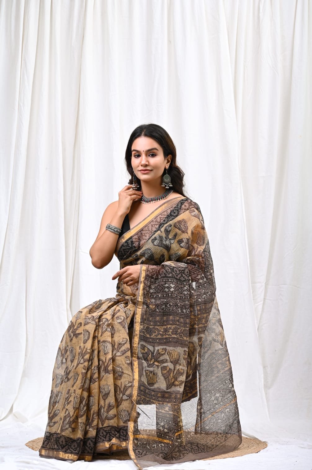 Beige and black saree with floral Bagru hand block print design