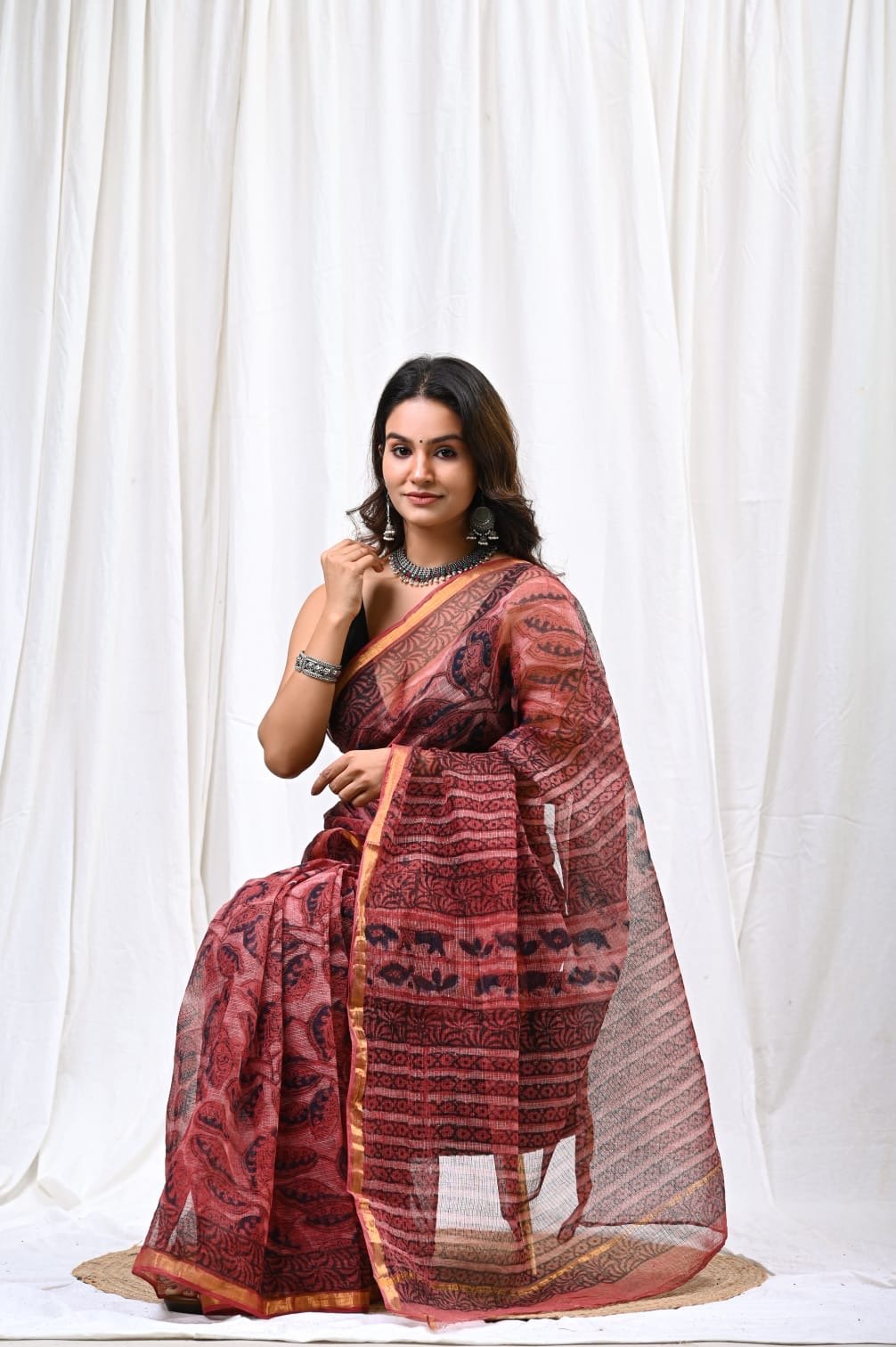 Maroon saree with floral motifs, showcasing Bagru hand block print