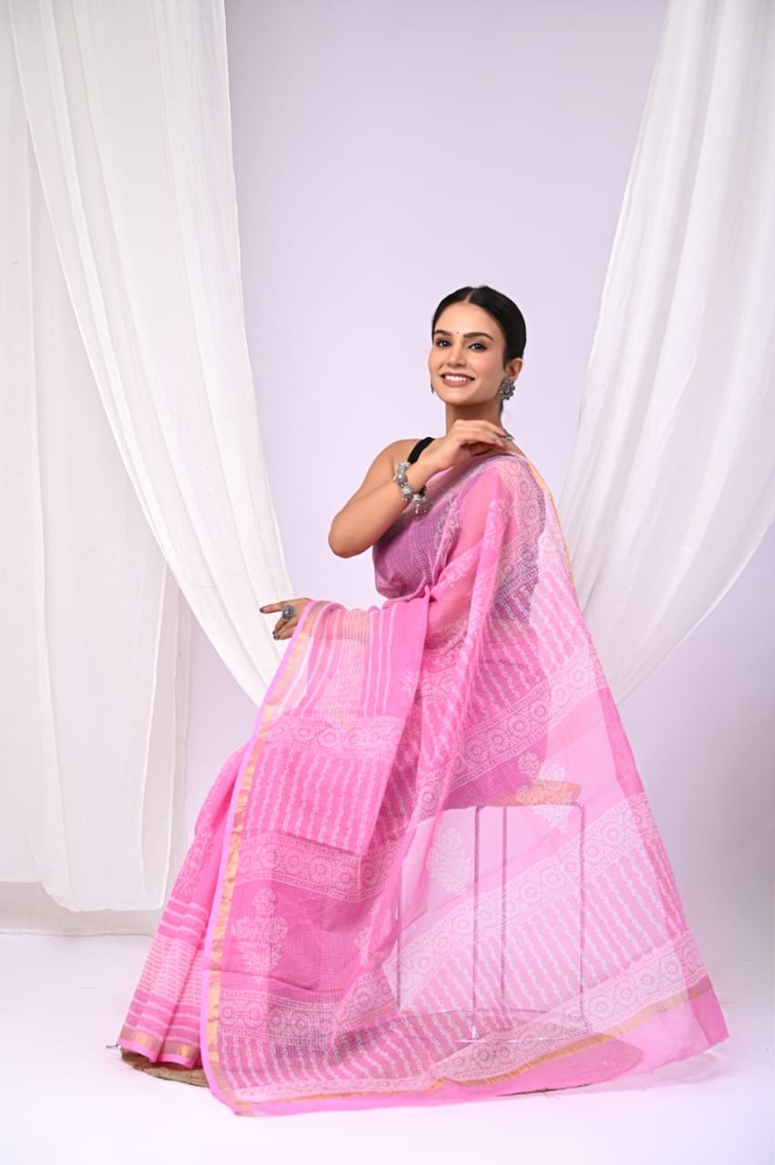 Vibrant pink saree with floral block print and golden border