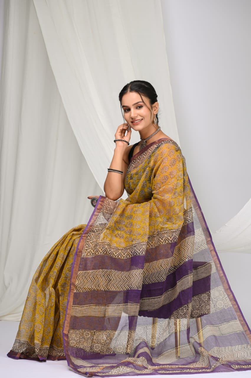 Yellow saree with floral motifs and purple border design