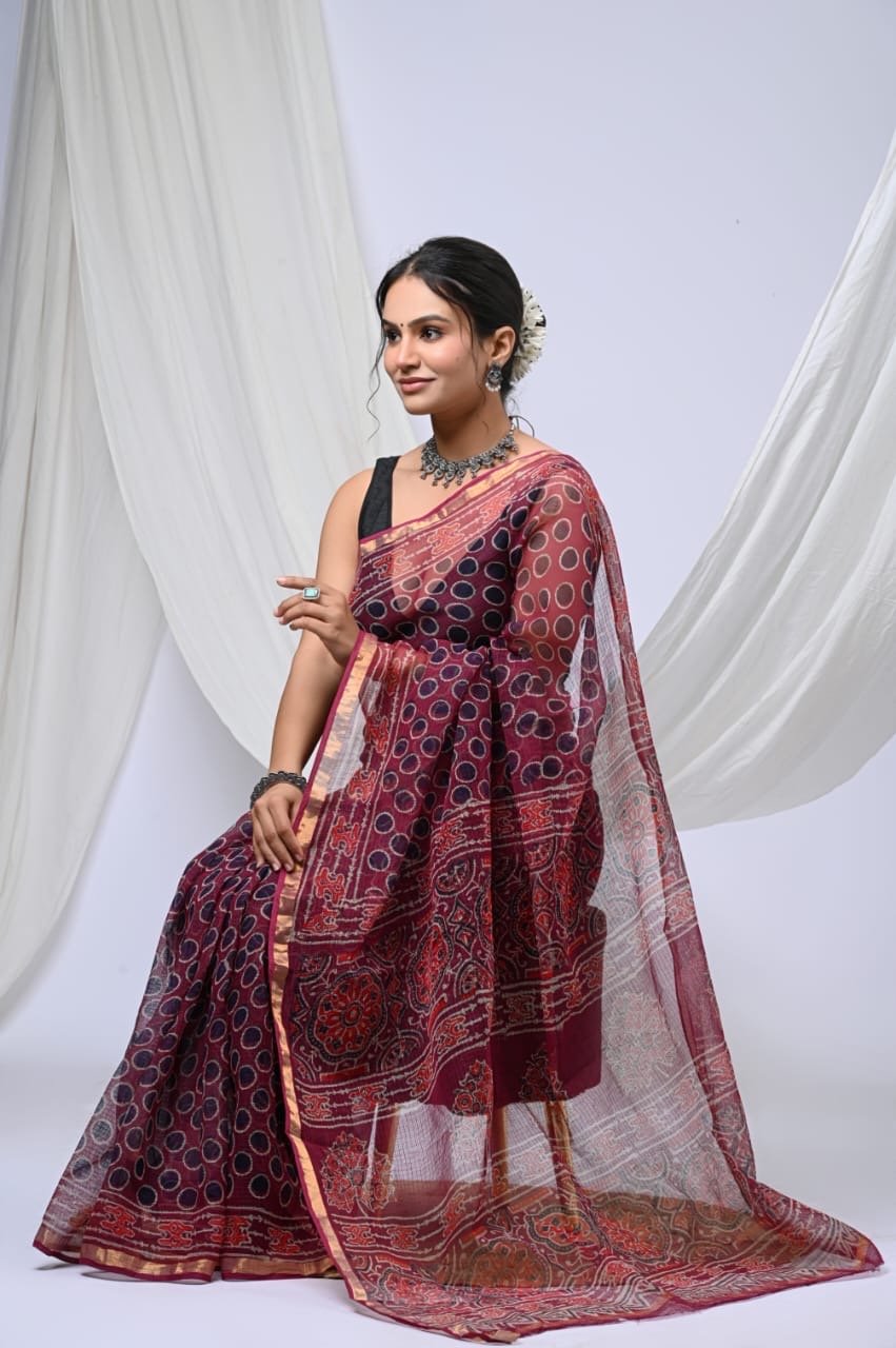 Maroon saree with polka dot motifs and floral border design