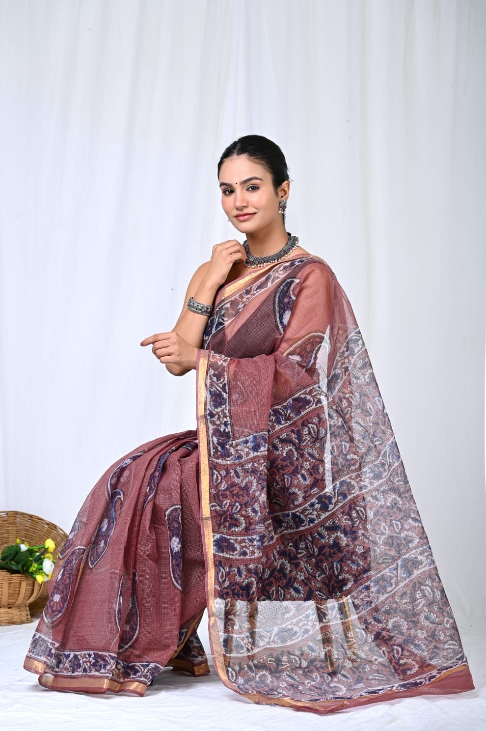 Maroon saree with floral Bagru block print, gold border, and khat texture