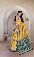 Yellow Mul Cotton saree with buta and green pallu motif