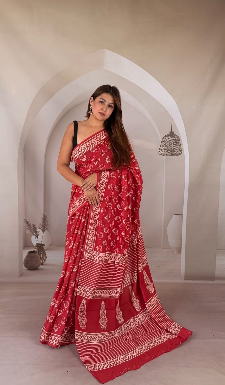 Red saree with buta motifs and intricate borders in Bagru print