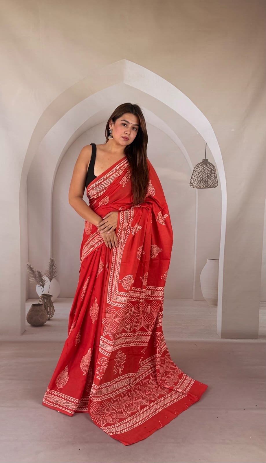 Red saree with fish motifs and intricate border in Bagru hand block print