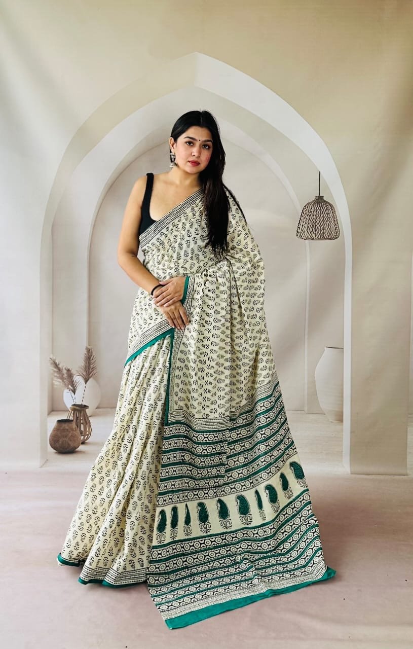 Cream and teal saree with floral motif and detailed border using Bagru hand block print