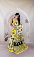 Yellow saree with black floral motifs and striped border in Bagru hand block print