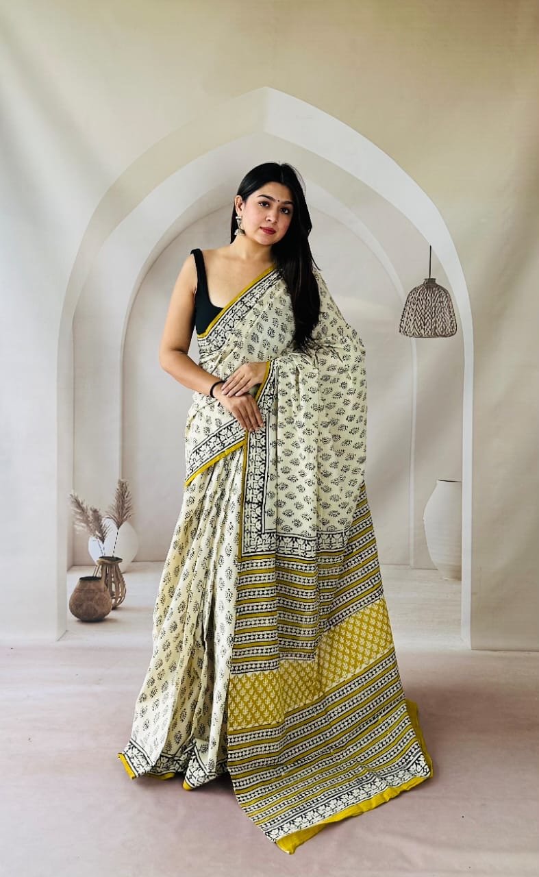 Saree with yellow and black floral motifs on Mul Cotton fabric