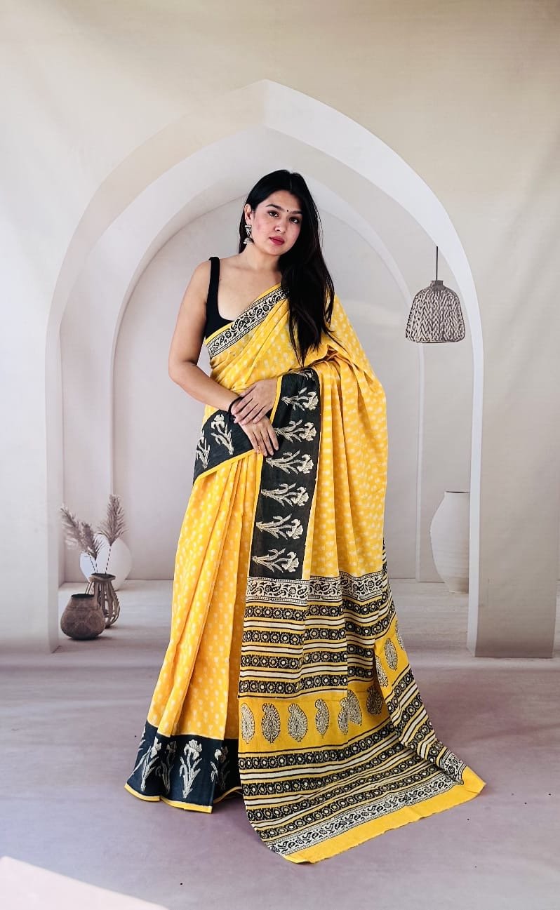 Yellow Mul Cotton saree with floral motifs and black border