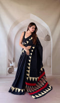 Black saree with geometric and paisley motifs in beige and red accents