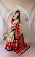Red and beige saree with floral and geometric motifs, traditional Bagru print.
