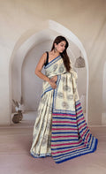 Cream saree with paisley motifs, blue and red striped border