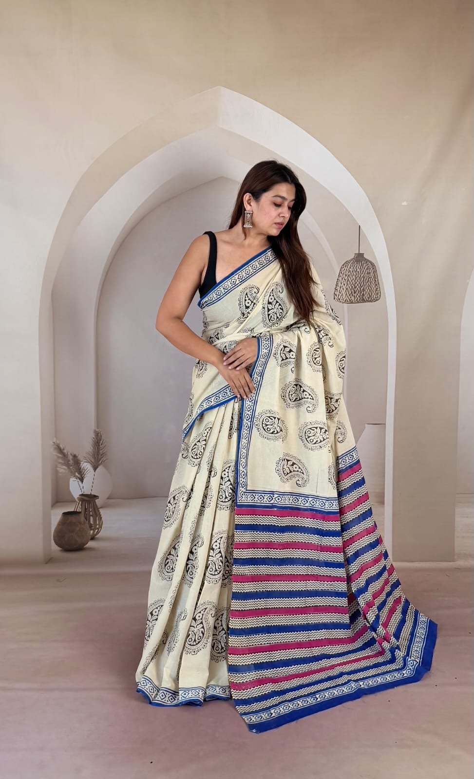 Cream saree with paisley motifs, blue and red striped border